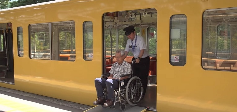 Station personnel assisting wheelchair user transit